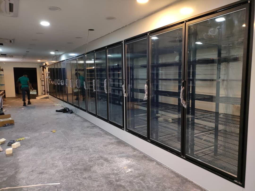 Glass-door display chillers freshly installed in a retail space